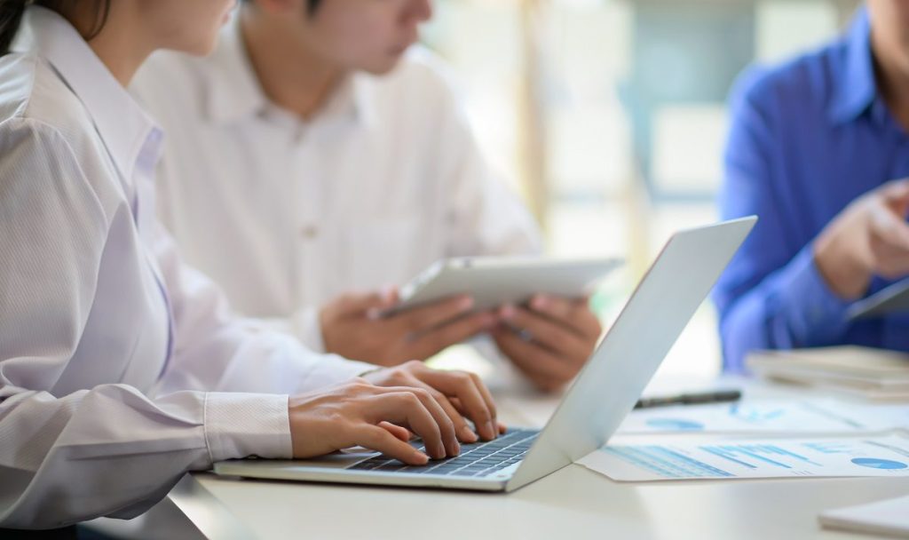 Professional team with laptop and tablet consult new projects fo