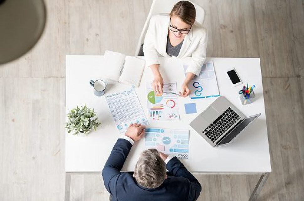 Analytical expert explaining statistics to businessman